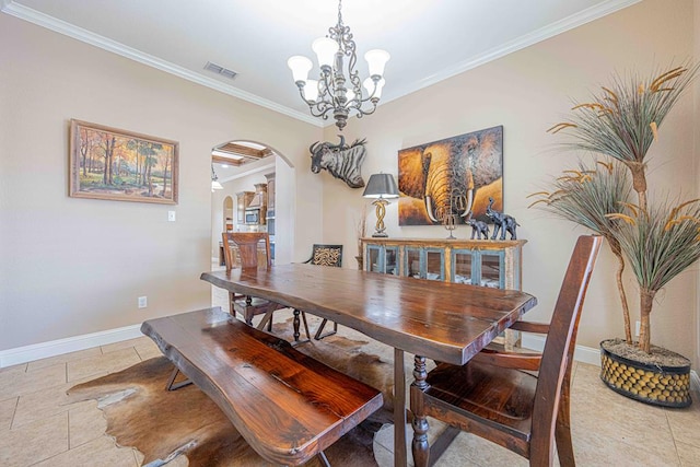 dining area featuring light tile patterned floors, ornamental molding, and a notable chandelier