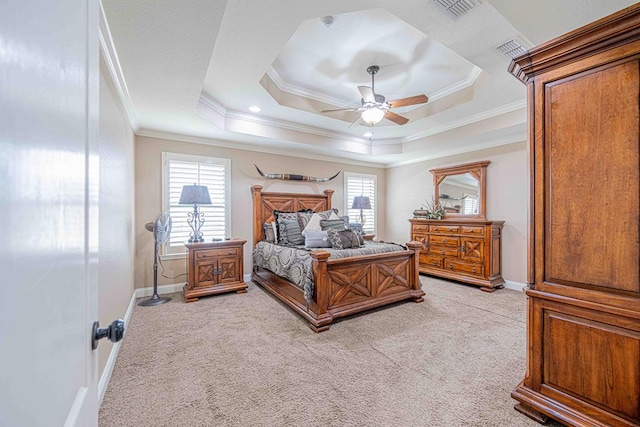 bedroom featuring ceiling fan, ornamental molding, light carpet, and a tray ceiling