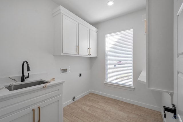 clothes washing area with hookup for a washing machine, a sink, a wealth of natural light, and hookup for an electric dryer