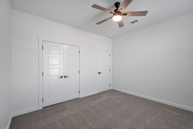 unfurnished bedroom with baseboards, visible vents, ceiling fan, carpet floors, and a closet