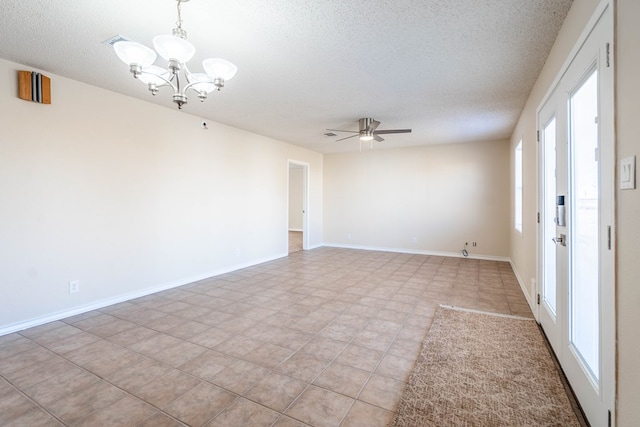 spare room featuring ceiling fan with notable chandelier, baseboards, and a textured ceiling