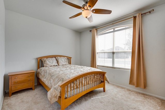 bedroom with light carpet and ceiling fan