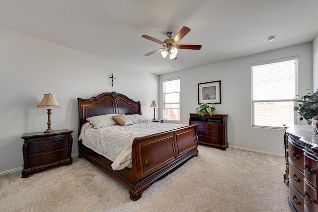 bedroom featuring baseboards, a ceiling fan, and light colored carpet