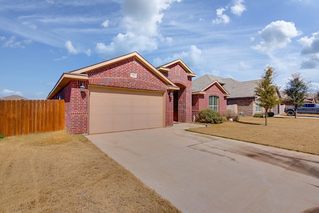 ranch-style house featuring driveway, a garage, fence, a front lawn, and brick siding