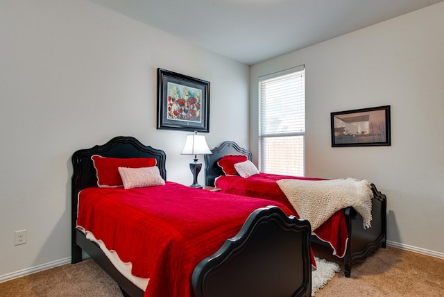 carpeted bedroom with baseboards