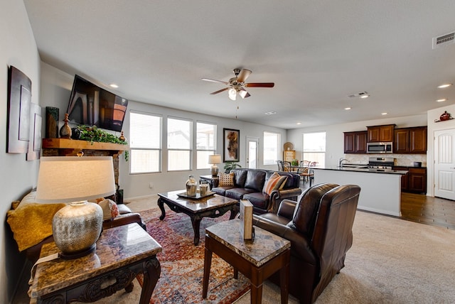 living room with light colored carpet, recessed lighting, visible vents, and ceiling fan