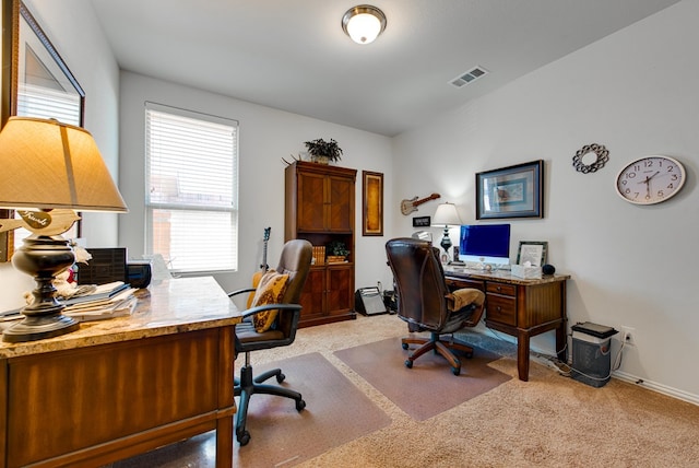 home office with light carpet, visible vents, and baseboards