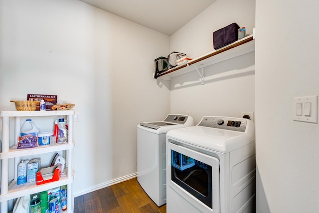 laundry area featuring laundry area, wood finished floors, washing machine and dryer, and baseboards