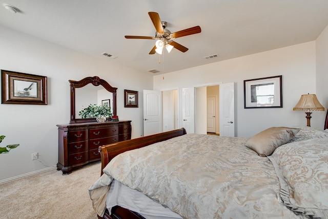 bedroom featuring light colored carpet, visible vents, and ceiling fan