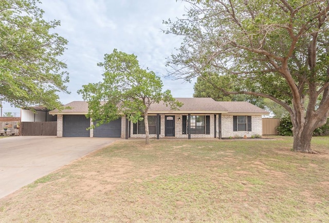 10807 E County Rd 104, Midland, TX 79706 - single story home featuring an attached garage, concrete driveway, brick siding, and roof with shingles