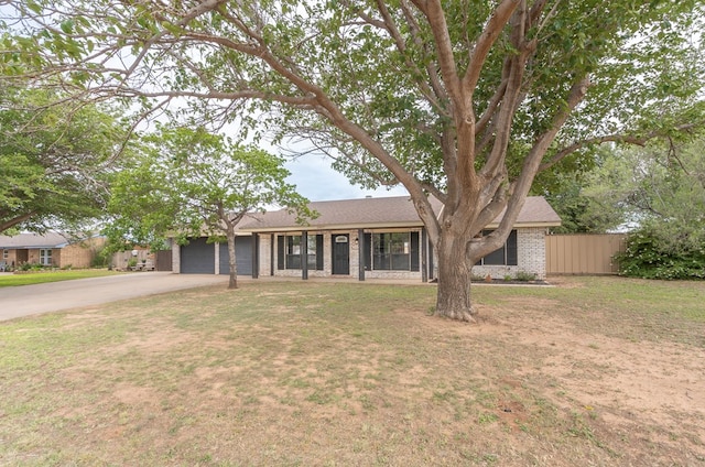 10807 E County Rd 104, Midland, TX 79706 - ranch-style home featuring driveway, an attached garage, brick siding, and roof with shingles