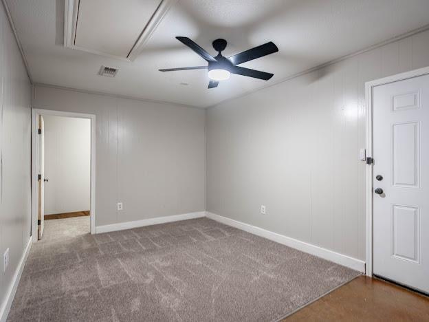 10807 E County Rd 104, Midland, TX 79706 - empty room featuring attic access, a ceiling fan, and carpet flooring