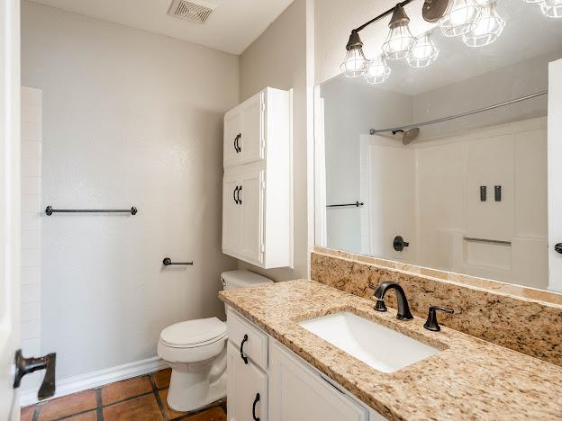 10807 E County Rd 104, Midland, TX 79706 - full bath featuring vanity, a shower, and tile patterned floors