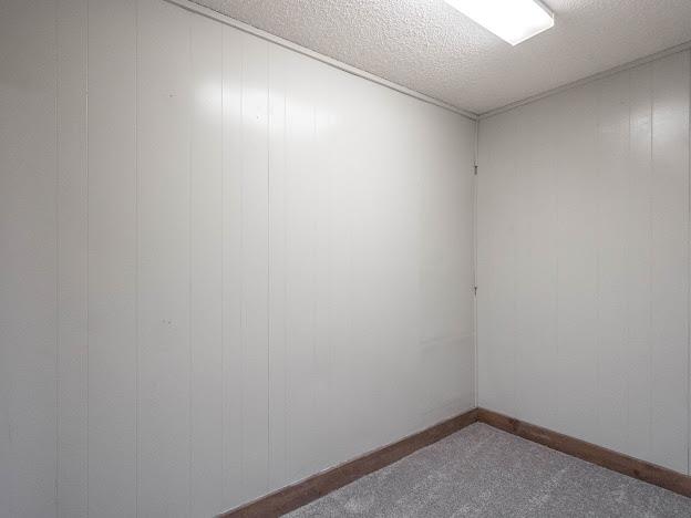 10807 E County Rd 104, Midland, TX 79706 - empty room with carpet floors and a textured ceiling