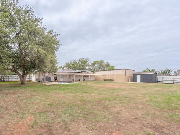 10807 E County Rd 104, Midland, TX 79706 - view of yard with an outbuilding, a patio, and a pool