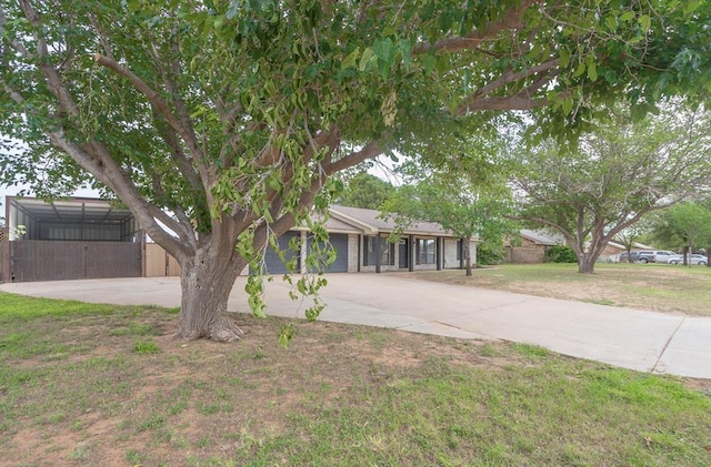 10807 E County Rd 104, Midland, TX 79706 - view of front of home featuring concrete driveway and an attached garage