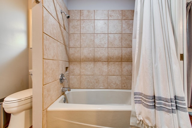 bathroom featuring shower / bath combination with curtain and toilet