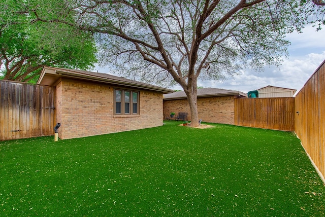 view of yard with a fenced backyard