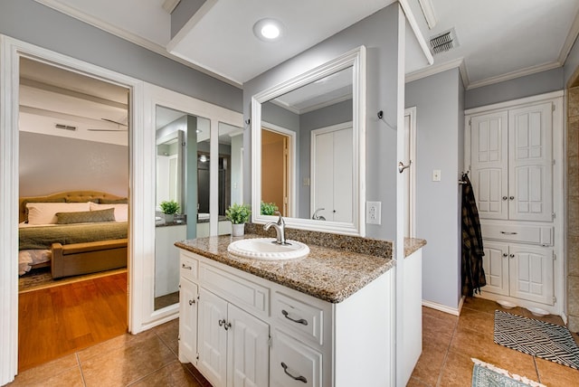 ensuite bathroom with tile patterned floors, vanity, connected bathroom, and visible vents