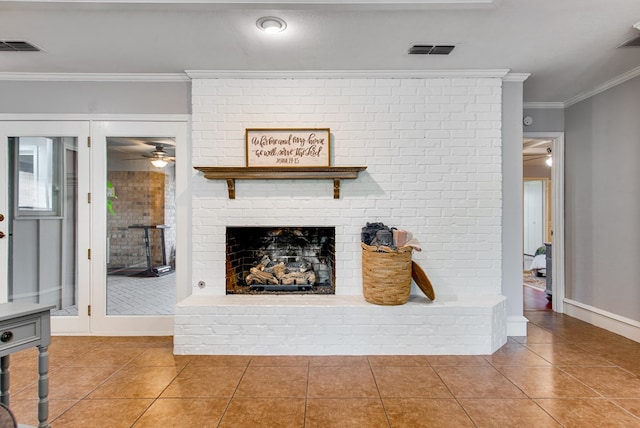 tiled living area with a brick fireplace, crown molding, ceiling fan, and visible vents