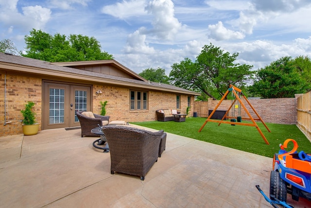 view of patio / terrace with french doors, a fenced backyard, outdoor lounge area, and a playground