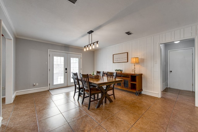 dining room with tile patterned floors, crown molding, visible vents, baseboards, and french doors