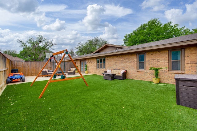 rear view of property featuring a patio, a playground, a yard, an outdoor living space, and a fenced backyard