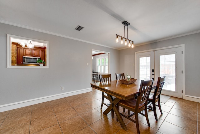 tiled dining room with french doors, baseboards, ornamental molding, and a notable chandelier