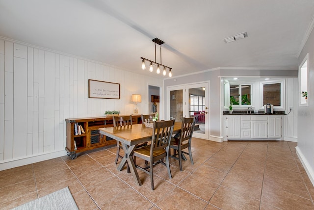 dining room with baseboards, visible vents, ornamental molding, and light tile patterned flooring
