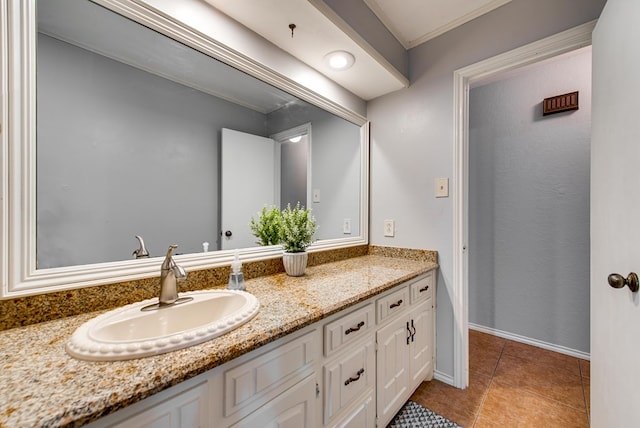 bathroom with crown molding, tile patterned flooring, and vanity