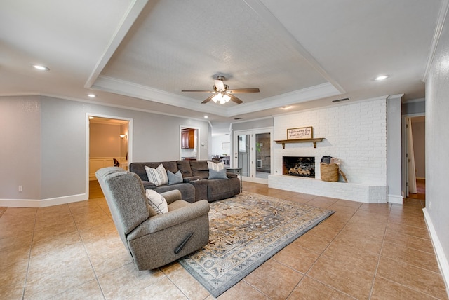 living room with tile patterned floors, a raised ceiling, ceiling fan, and crown molding