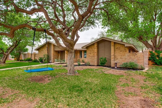 mid-century home featuring brick siding and a front lawn