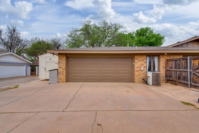 exterior space featuring fence, central AC unit, and driveway