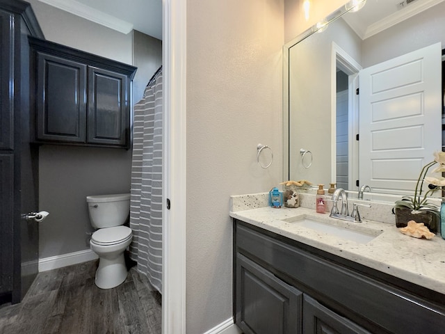 bathroom featuring toilet, vanity, ornamental molding, and hardwood / wood-style floors