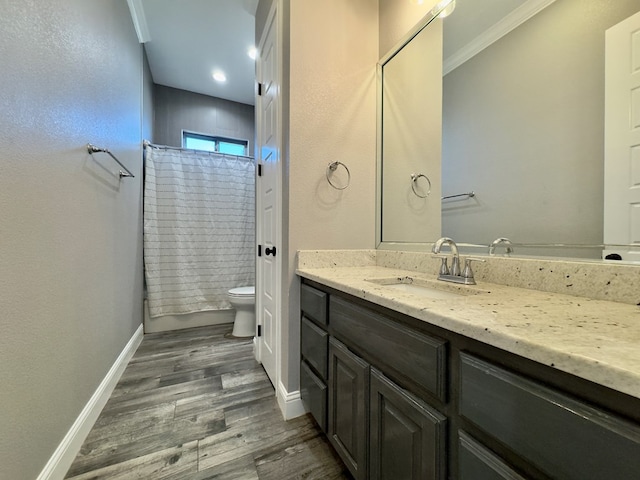 full bathroom with wood-type flooring, vanity, shower / tub combo, toilet, and crown molding