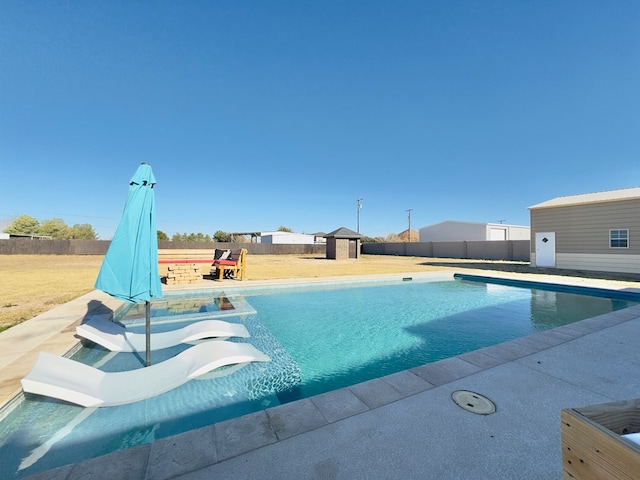 view of swimming pool with a storage shed