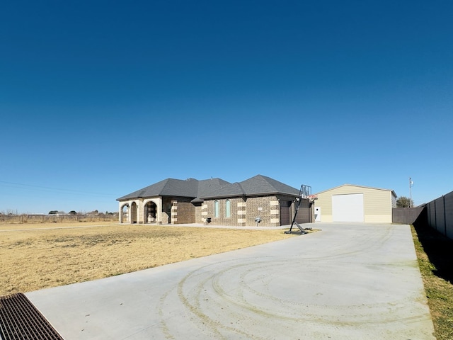 view of front facade featuring a garage and an outdoor structure