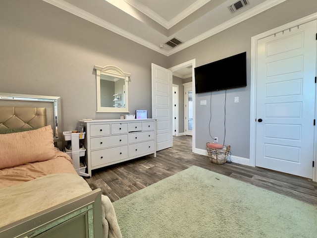 bedroom with dark hardwood / wood-style floors, a raised ceiling, and crown molding