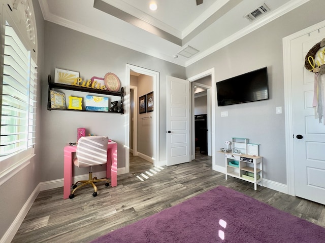 living area featuring dark wood-type flooring, ornamental molding, and a raised ceiling