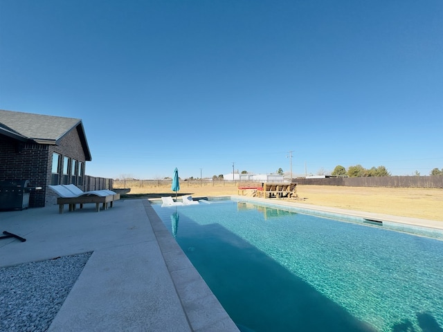 view of pool with a patio area and area for grilling