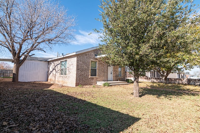 rear view of house with a yard