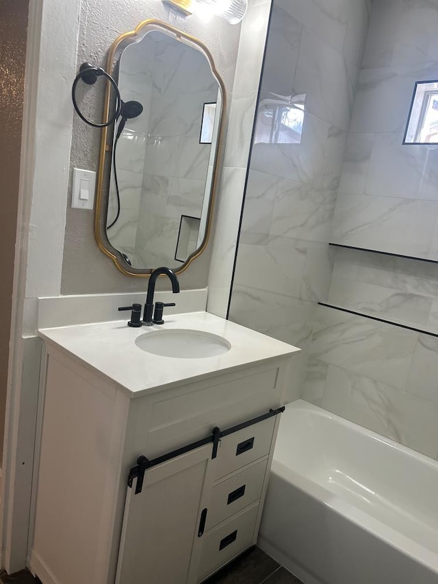 bathroom with vanity and tiled shower / bath combo