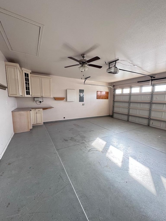 garage with ceiling fan and a garage door opener