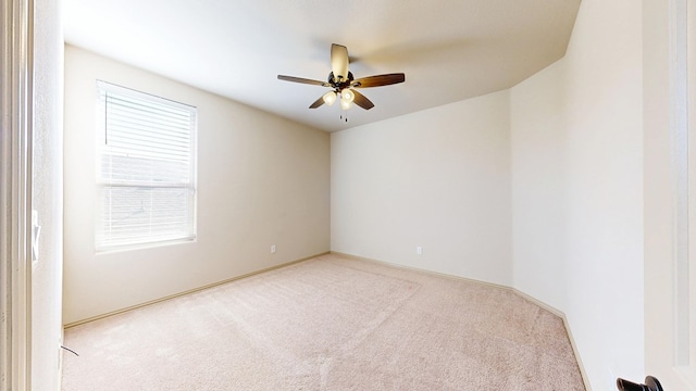 carpeted empty room featuring ceiling fan