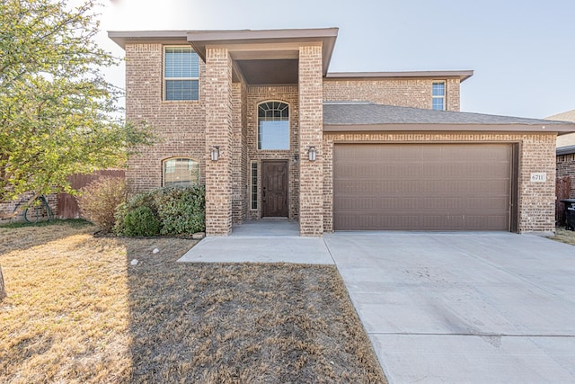 view of front of property with a garage, concrete driveway, and brick siding