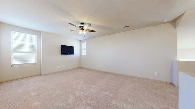 unfurnished room with light carpet, ceiling fan, and visible vents