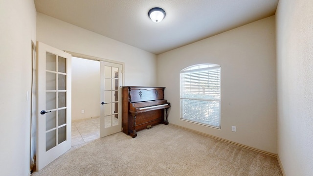 interior space with carpet floors and french doors