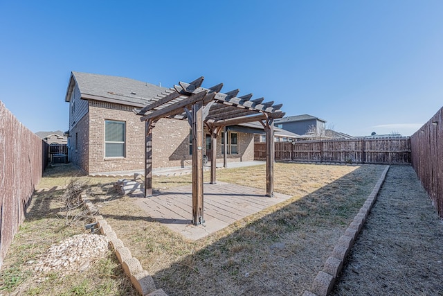 back of house with brick siding, a patio area, a fenced backyard, and a pergola