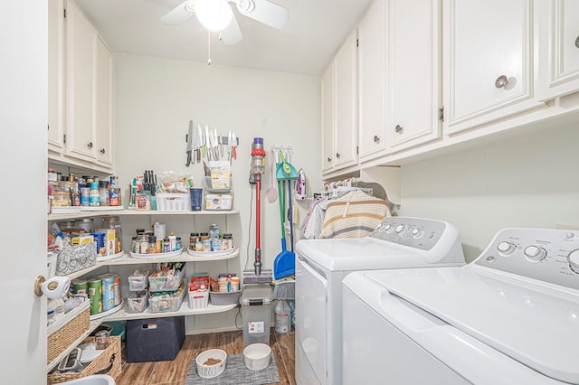 clothes washing area featuring ceiling fan, wood finished floors, washing machine and clothes dryer, and cabinet space