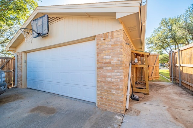 detached garage featuring fence